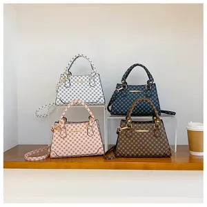 Detailed view of vintage monogram shoulder bags in beige, blue, pink and brown colors