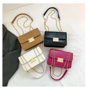 Detail of square chain bags in four colors with crocodile pattern and gold buckle