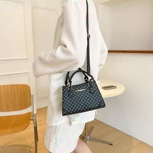 Vintage geometric pattern handbag for women with gold hardware and adjustable strap
