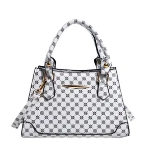 Minimalist white tote bag with black floral clover pattern and gold hardware