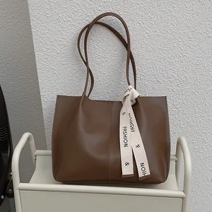 Retro brown leather tote bag for women with fashion ribbon detail and spacious interior