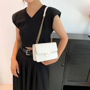 White crocodile pattern square crossbody bag with gold chain strap and buckle closure