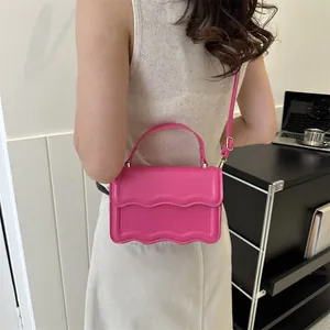 Chic magenta square shoulder bag with wavy edge design and gold metal hardware links
