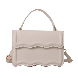 Chic beige PU leather handbag with wavy edge flap and adjustable crossbody strap
