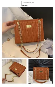 Detailed view of brown quilted faux leather bag with gold chain strap and metal lock