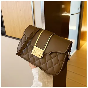 Detailed view of brown PU leather shoulder bag with quilted pattern and gold metal clasp