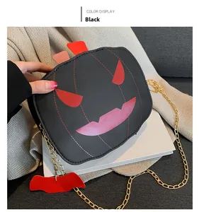 Λεπτομέρεια μαύρης τσάντας κολοκύθας Halloween με κόκκινο πρόσωπο και χρυσή αλυσίδα
