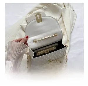 Interior view showing the large capacity of the white quilted chain crossbody bag