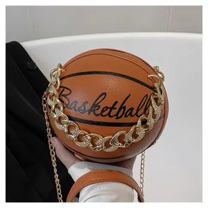 Macro detail of basketball shape bag with orange texture and gold rhinestone chain