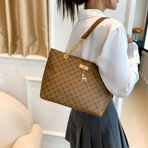 Brown large capacity tote bag with cross pattern and golden deer pendant detail