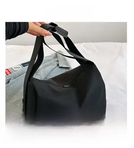 Close-up of black oxford tote bag showing durable wide shoulder strap and zipper closure
