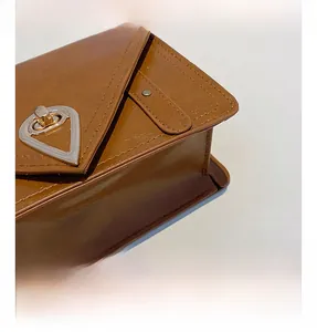 Detail of warm brown leather texture with silver triangle rotary metal lock closure