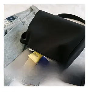 Macro shot of spacious black oxford tote bag interior with multiple daily essentials