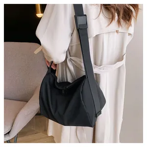 Close-up of wide adjustable strap and high-quality nylon fabric on black tote bag