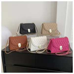 Detailed view of colorful quilted crossbody bags with gold chain straps and metal locks
