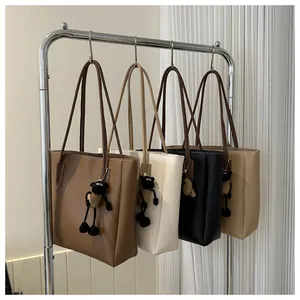 Detail of four colorful tote bags hanging with cute sheep charms and contrast stitching