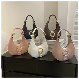 Selection of crescent moon handbags in pink, black, brown and white with gold buckles