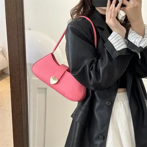 Pink PU leather underarm bag with gold heart buckle shown in a stylish mirror selfie