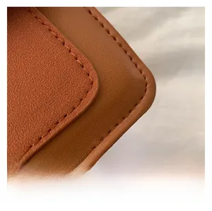 Detail of brown leather texture with premium stitching on this vintage crossbody bag