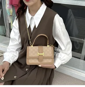 Chic beige plaid square handbag with gold H-buckle worn by a model in casual attire