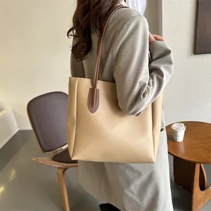 Minimalist large capacity tote bag with brown straps for modern women's daily commute