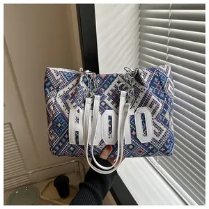Detail of HOOTO ethnic style tote bag featuring geometric patterns and chain strap