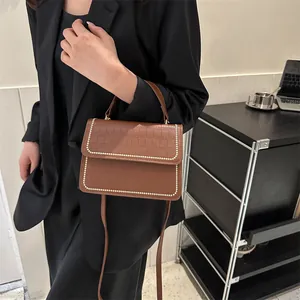 Brown crocodile texture shoulder bag with gold rivets and detachable strap