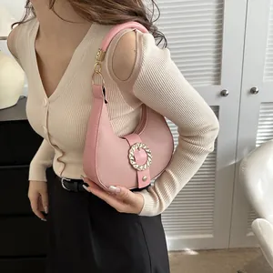 Pink lychee grain faux leather crescent hobo bag with gold ring buckle and round handle