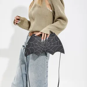 Gothic bat-shaped crossbody bag featuring white spider web stitching on black PU leather