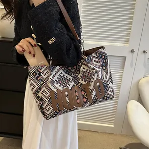 Ethnic knit tote bag with pink and blue geometric patterns and brown leather strap