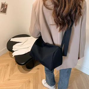 Minimalist large black oxford tote bag shown on a model for daily commuting use