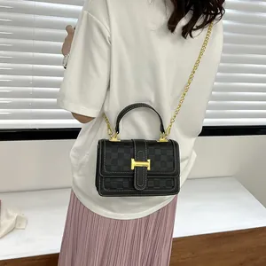 Black checkered shoulder bag with gold H-buckle and chain strap shown on a model