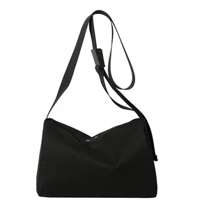 Large black Oxford fabric tote bag with top zipper and adjustable strap for daily commute
