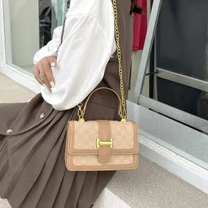 Elegant beige checkered crossbody bag with gold H-buckle and chain strap shown on a model