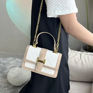 Women's woven shoulder bag with gold chain and top handle in a minimalist beige design