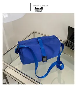 Detalle del bolso bandolera de nailon azul pequeño con correa ajustable sobre escritorio