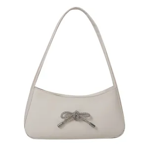 Chic cream white underarm bag featuring a sparkling rhinestone bow on matte PU leather