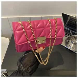 Détail du sac matelassé rouge rose en simili cuir avec chaîne dorée et fermoir métal