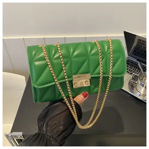 Détail du sac matelassé vert vif avec un fermoir en métal doré et une chaîne dorée