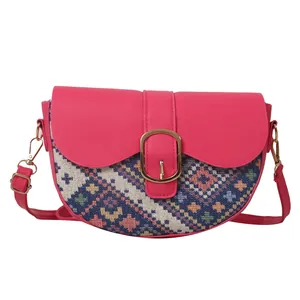 Ethnic style rose pink saddle crossbody bag with colorful woven patterns and gold buckle