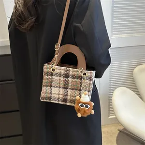 Retro houndstooth tweed handbag with brown leather strap and cute plush pom-pom charm