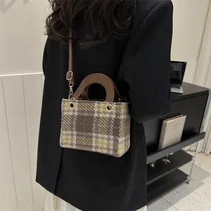 Chic houndstooth plaid crossbody bag with brown leather handles for autumn fashion