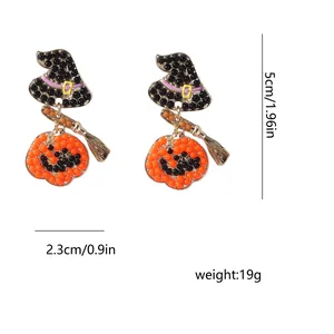Vue détaillée des boucles d'oreilles d'Halloween avec chapeau de sorcière, balai et citrouille