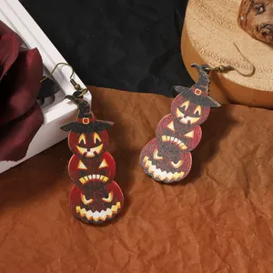 Dettaglio di orecchini di legno per Halloween con zucche impilate e cappello da mago