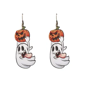 Detail of wooden Halloween drop earrings featuring cartoon ghost and pumpkin motifs
