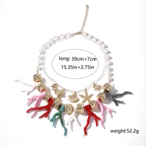 Detail view of layered ocean necklace with pearls, coral charms and size specifications