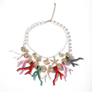 Double-layered beach necklace with pearls, colorful coral branches and gold sea charms