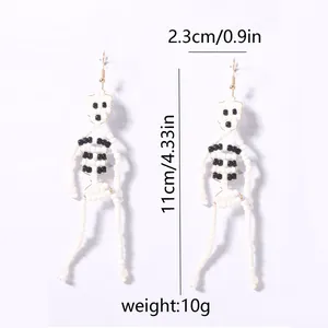 Detail view of handmade beaded skull earrings for Halloween with specific size measurements