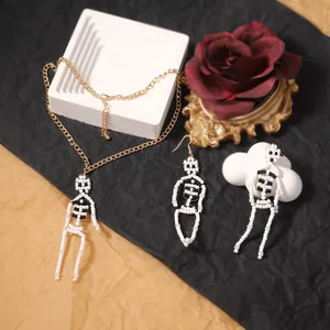 Handmade Halloween beaded skull jewelry set with necklace and earrings on gold chains
