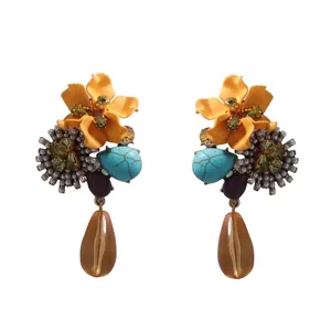 Close-up of vintage resin flower earrings with colorful beads and amber waterdrop charms